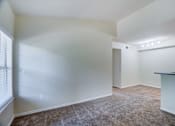 Thumbnail 11 of 20 - A room with white walls and carpeted floor.