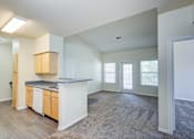 Thumbnail 5 of 20 - A kitchen with wooden cabinets and a countertop is shown.