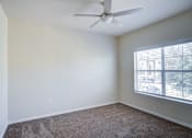 Thumbnail 12 of 20 - A room with a ceiling fan and a window with blinds.
