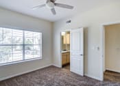 Thumbnail 9 of 20 - A room with a ceiling fan and a window with blinds.