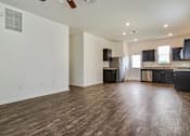 Thumbnail 64 of 75 - A spacious kitchen with dark wood floors and modern appliances.