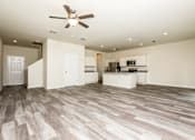 Thumbnail 10 of 38 - A spacious room with a ceiling fan and lighting fixtures.
