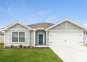 Thumbnail 2 of 46 - 4 BR Apartments in North Denton, TX - Beall Way - Home Exterior with Driveway, Two-Car Garage, and Green Grass.