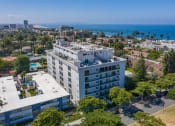 Thumbnail 20 of 29 - an aerial view of a large white building with a view of the ocean in the background