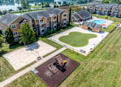 Thumbnail 2 of 31 - Pet-Friendly Apartments in Oak Ridge, TN – Centennial Village – an aerial view of our apartment complex with view of our pool, putting green, and volleyball court