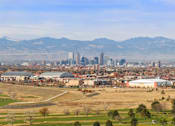 Thumbnail 51 of 51 - A cityscape with a mountain range in the background.