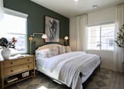 Thumbnail 15 of 16 - A bedroom with a large bed, a wooden dresser, and a painting on the wall.