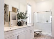 Thumbnail 16 of 16 - A bathroom with a white cabinet and a white sink.