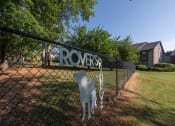 Thumbnail 22 of 31 - Lawrenceville, GA Apartments – Park on Sweetwater – a sign on a fence in front of a dog park