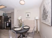 Thumbnail 9 of 31 - Apartments in Lawrenceville Georgia for Rent – Park on Sweetwater - a dining room with a table and chairs and a kitchen