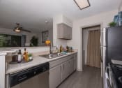 Thumbnail 7 of 31 - Lawrenceville, GA Apartments – Park on Sweetwater – redesigned kitchen with stainless steel appliances and granite counter tops and a large window