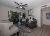 Thumbnail 10 of 31 - Lawrenceville, GA Apartments – Park on Sweetwater – a living room with a ceiling fan and a couch