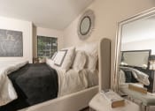 Thumbnail 14 of 31 - Lawrenceville, GA Apartments – Park on Sweetwater – spacious bedroom with a large mirror and a bed with white and black pillows and