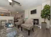 Thumbnail 11 of 31 - Pet-Friendly Apartments in Lawrenceville– Park on Sweetwater – a living room with couches and chairs and a fireplace