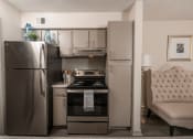 Thumbnail 1 of 31 - Lawrenceville, GA Apartments – Park on Sweetwater – a kitchen with stainless steel appliances and a stainless steel refrigerator