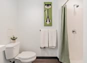 Thumbnail 21 of 54 - A white toilet sits next to a white sink in a bathroom.