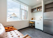 Thumbnail 32 of 54 - A kitchen with a refrigerator, sink, and a window overlooking a cityscape.