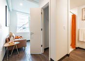 Thumbnail 29 of 54 - A bathroom with a towel rack and a painting on the wall.