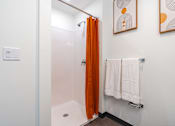 Thumbnail 26 of 54 - A bathroom with a white towel hanging on a rack.