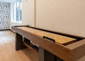 Thumbnail 38 of 54 - A pool table with a brown cloth and white balls is in the middle of a room with a window and curtains.