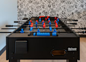 Thumbnail 3 of 54 - A black GoSticky foosball table with red and blue players.
