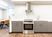 Thumbnail 43 of 54 - A modern kitchen with a stainless steel oven and cabinets.
