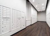 Thumbnail 44 of 54 - A long hallway with white lockers on the wall.