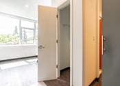 Thumbnail 9 of 54 - A white door is open to a hallway.