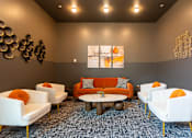 Thumbnail 34 of 54 - A living room with white chairs and an orange couch.