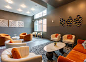 Thumbnail 35 of 54 - A living room with orange and white furniture.