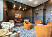 Thumbnail 36 of 54 - A room with orange chairs and a white couch.