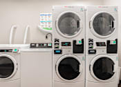 Thumbnail 46 of 54 - A row of washing machines with the number 35 on the front of the second one from the right.