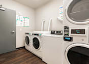 Thumbnail 45 of 54 - A row of washing machines in a laundromat.