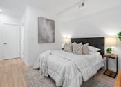 Thumbnail 57 of 78 - A bedroom with a large bed and a painting on the wall.