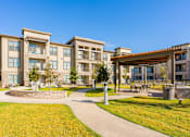 Thumbnail 21 of 29 - A large building with a courtyard in front of it.
