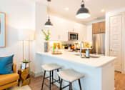 Thumbnail 6 of 29 - A kitchen with a white counter and a stainless steel refrigerator.
