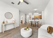 Thumbnail 1 of 15 - Kissimmee, FL Townhomes for Rent - Estates at Lake Cecile – A modern living room with a white couch and a round mirror on the wall.