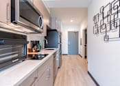 Thumbnail 4 of 40 - A modern kitchen with a wall art on the wall.