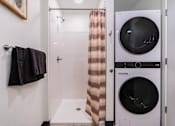 Thumbnail 14 of 40 - A small bathroom with a washer and dryer.