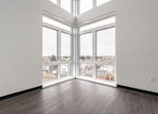 Thumbnail 26 of 40 - A room with a large window and a view of a snowy landscape.