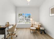 Thumbnail 11 of 15 - Kissimmee, FL Townhomes for Rent - Estates at Lake Cecile – A room with a desk, chair, and window with blinds.