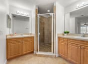 Thumbnail 10 of 15 - Three- & Four-Bedroom Townhomes in Kissimmee, FL - Estates at Lake Cecile –A bathroom with a walk-in shower and double sinks.