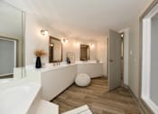 Thumbnail 44 of 51 - A bathroom with a white sink and a white vanity.