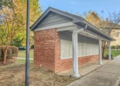 Thumbnail 19 of 29 - Twin Oaks Apartments in Hattiesburg Mississippi photo of a covered parking lot in front of a house