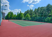 Thumbnail 4 of 25 - Outdoor tennis court at Lancaster Place in Calera, Alabama, with clean playing surface and surrounding fencing.