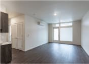 Thumbnail 9 of 18 - an empty living room with white walls and wood floors