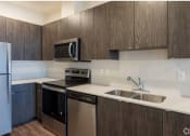 Thumbnail 8 of 18 - a kitchen with a stove top oven next to a sink