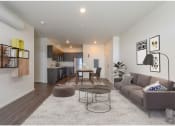 Thumbnail 1 of 18 - a living room with a couch and a table