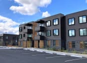 Thumbnail 18 of 18 - a row of new apartment buildings in a parking lot