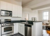 Thumbnail 5 of 38 - Kitchen with white cabinets and stainless appliances